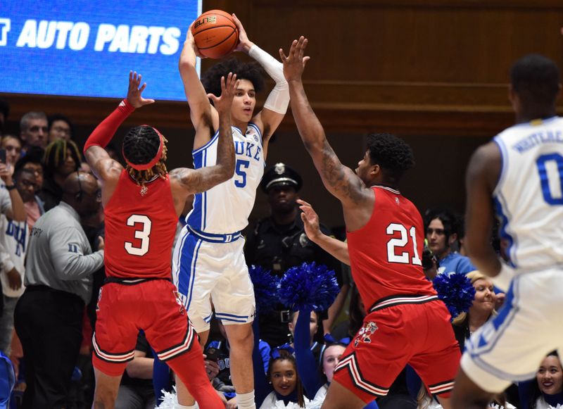 Feb 20, 2023; Durham, North Carolina, USA; Duke Blue Devils guard Tyrese Proctor(5) looks to pas as Louisville Cardinals forward Sydney Curry (21) and guard El Ellis (3) defend during the first half at Cameron Indoor Stadium. Mandatory Credit: Rob Kinnan-USA TODAY Sports