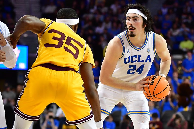 Mar 2, 2023; Los Angeles, California, USA; UCLA Bruins guard Jaime Jaquez Jr. (24) controls the ball against Arizona State Sun Devils guard Devan Cambridge (35) during the second half at Pauley Pavilion. Mandatory Credit: Gary A. Vasquez-USA TODAY Sports