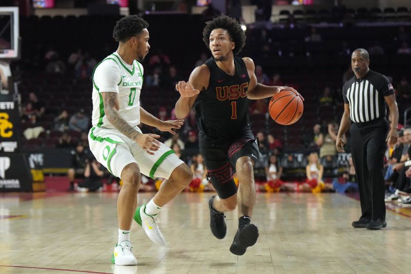 Dec 4, 2024; Los Angeles, California, USA; Southern California Trojans guard Desmond Claude (1) dribbles the ball against Oregon Ducks guard Ra'Heim Moss (0) in the first half at Galen Center. Mandatory Credit: Kirby Lee-Imagn ImagesDec 4, 2024; Los Angeles, California, USA; at Galen Center. Mandatory Credit: Kirby Lee-Imagn Images