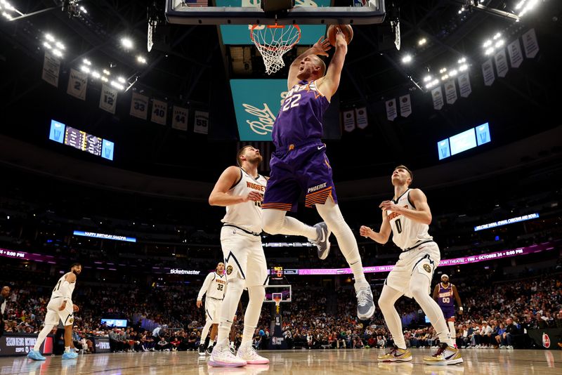 DENVER, COLORADO - OCTOBER 13: Mason Plumlee #44 of the Phoenix Suns tries to grab a rebound against the Denver Nuggets in the first half at Ball Arena on October 13, 2024 in Denver, Colorado. NOTE TO USER: User expressly acknowledges and agrees that, by downloading and/or using this Photograph, user is consenting to the terms and conditions of the Getty Images License Agreement. (Photo by Jamie Schwaberow/Getty Images)