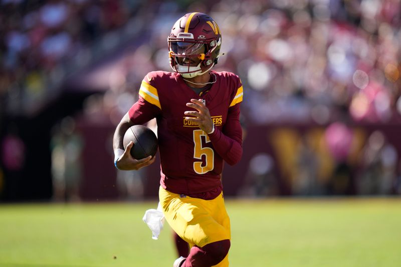 Washington Commanders quarterback Jayden Daniels (5) runs against the Cleveland Browns during the second half of an NFL football game in Landover, Md., Sunday, Oct. 6, 2024. (AP Photo/Stephanie Scarbrough)