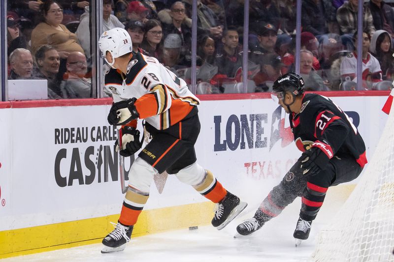 Feb 15, 2024; Ottawa, Ontario, CAN; Anaheim Ducks defenseman Gustav Lindstrom (28) moves the puck away from Ottawa Senators right wing Mathieu Joseph (21) in the first period at the Canadian Tire Centre. Mandatory Credit: Marc DesRosiers-USA TODAY Sports