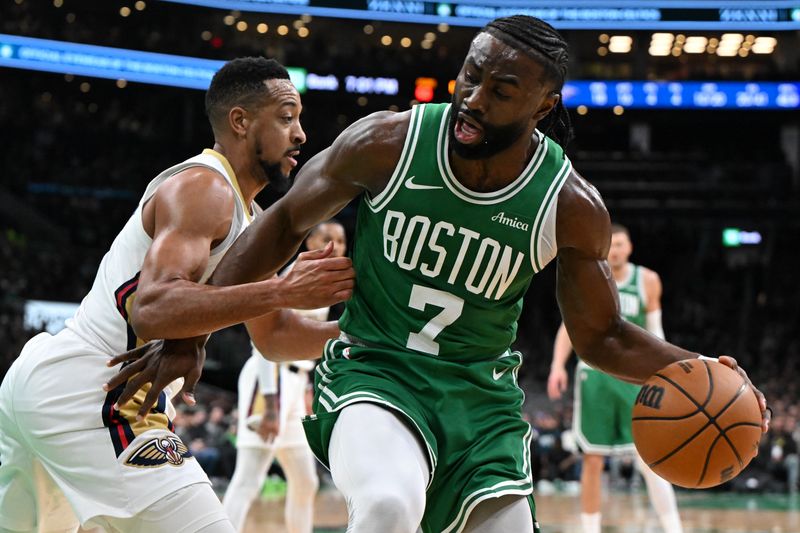 BOSTON, MASSACHUSETTS - JANUARY 12: Jaylen Brown #7 of the Boston Celtics drives to the basket against CJ McCollum #3 of the New Orleans Pelicans during the second quarter at the TD Garden on January 12, 2025 in Boston, Massachusetts. NOTE TO USER: User expressly acknowledges and agrees that, by downloading and or using this photograph, User is consenting to the terms and conditions of the Getty Images License Agreement. (Photo by Brian Fluharty/Getty Images)