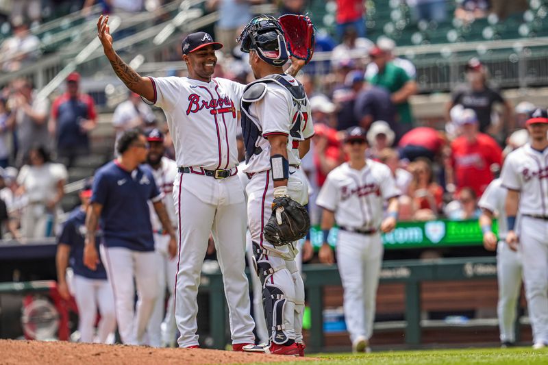 May 15, 2025; Cumberland, Georgia, USA; Atlanta Braves pitcher Raisel Iglesias (26) reacts with catcher Drake Baldwin (30) after the final out against the Washington Nationals during the ninth inning at Truist Park. Mandatory Credit: Dale Zanine-Imagn Images