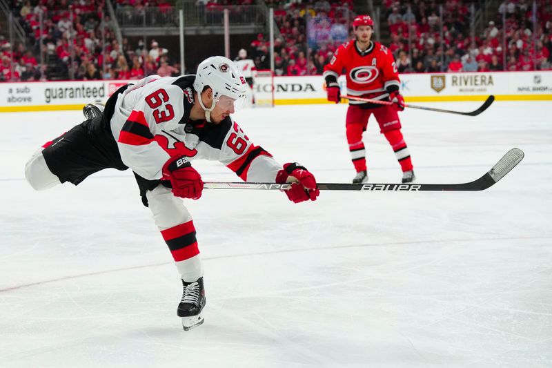 May 11, 2023; Raleigh, North Carolina, USA; New Jersey Devils left wing Jesper Bratt (63) shoots against the Carolina Hurricanes during the second period in game five of the second round of the 2023 Stanley Cup Playoffs at PNC Arena. Mandatory Credit: James Guillory-USA TODAY Sports