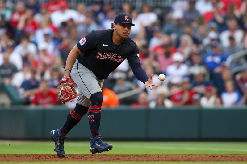 Apr 27, 2024; Atlanta, Georgia, USA; Cleveland Guardians first baseman Josh Naylor (22) throws a runner out at first against the Atlanta Braves in the first inning at Truist Park. Mandatory Credit: Brett Davis-USA TODAY Sports