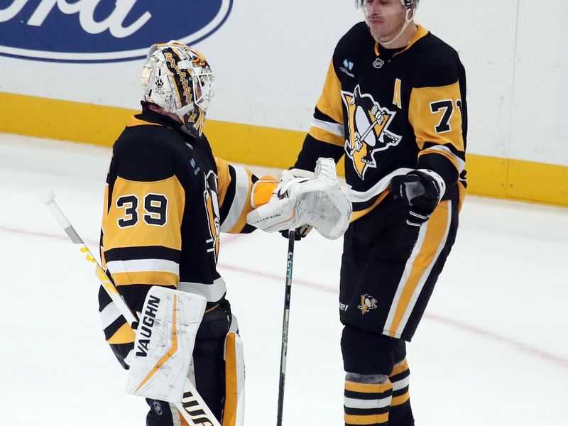 Nov 16, 2024; Pittsburgh, Pennsylvania, USA;  Pittsburgh Penguins goaltender Alex Nedeljkovic (39) and center Evgeni Malkin (71) celebrate after a shootout victory over the San Jose Sharks at PPG Paints Arena. Mandatory Credit: Charles LeClaire-Imagn Images