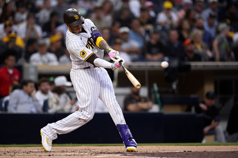 Aug 21, 2023; San Diego, California, USA; San Diego Padres third baseman Manny Machado (13) hits a sacrifice fly against the Miami Marlins during the first inning at Petco Park. Mandatory Credit: Orlando Ramirez-USA TODAY Sports