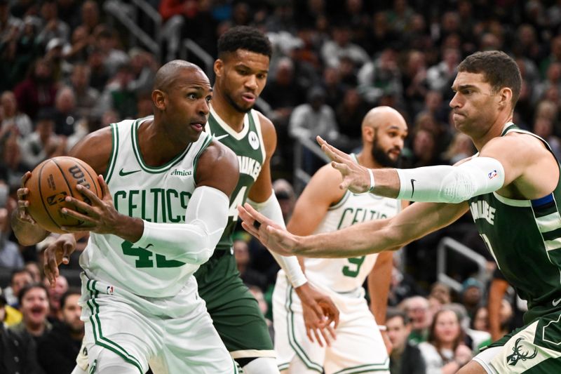 BOSTON, MASSACHUSETTS - OCTOBER 28: Al Horford #42 of the Boston Celtics controls the ball against Brook Lopez (R) #11 of the Milwaukee Bucks during the first half at the TD Garden on October 28, 2024 in Boston, Massachusetts. NOTE TO USER: User expressly acknowledges and agrees that, by downloading and or using this photograph, User is consenting to the terms and conditions of the Getty Images License Agreement. (Photo by Brian Fluharty/Getty Images)