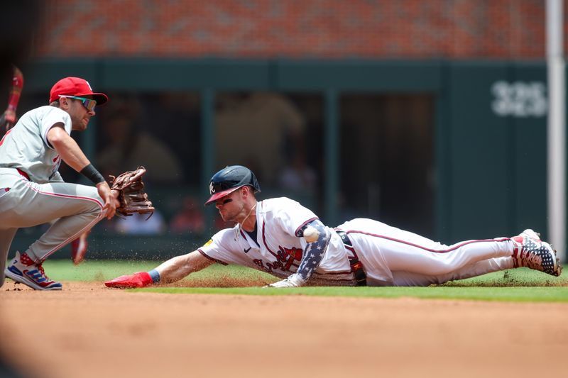 Jul 7, 2024; Atlanta, Georgia, USA; Atlanta Braves center fielder Jarred Kelenic (24) slides safely into second with a stolen base past the tag of Philadelphia Phillies shortstop Trea Turner (7) in the first inning at Truist Park. Mandatory Credit: Brett Davis-USA TODAY Sports
