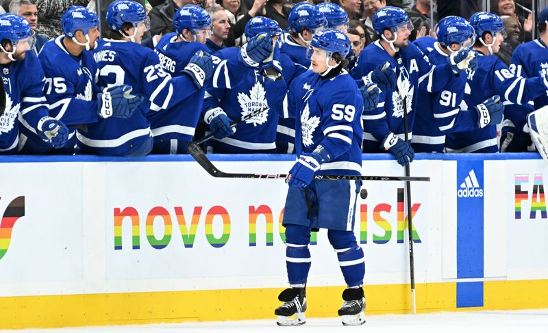 Feb 27, 2024; Toronto, Ontario, CAN;  Toronto Maple Leafs forward Tyler Bertuzzi (59) celebrates with team mates at the bench after scoring against the Vegas Golden Knights in the second  period at Scotiabank Arena. Mandatory Credit: Dan Hamilton-USA TODAY Sports