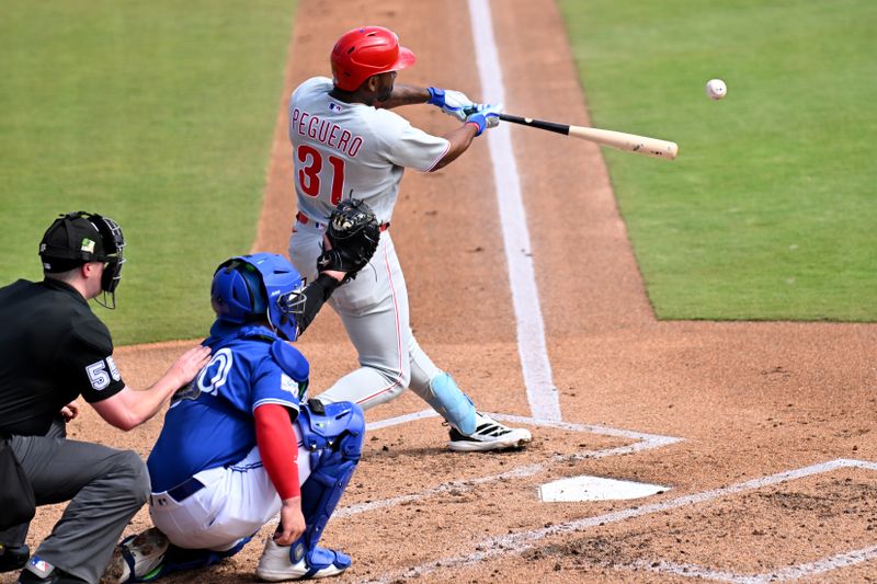 Feb 28, 2026; Dunedin, Florida, USA;  Philadelphia Phillies second baseman Liover Peguero (31) hits a single in the second  inning against the Toronto Blue Jays during spring training  at TD Ballpark. Mandatory Credit: Jonathan Dyer-Imagn Images