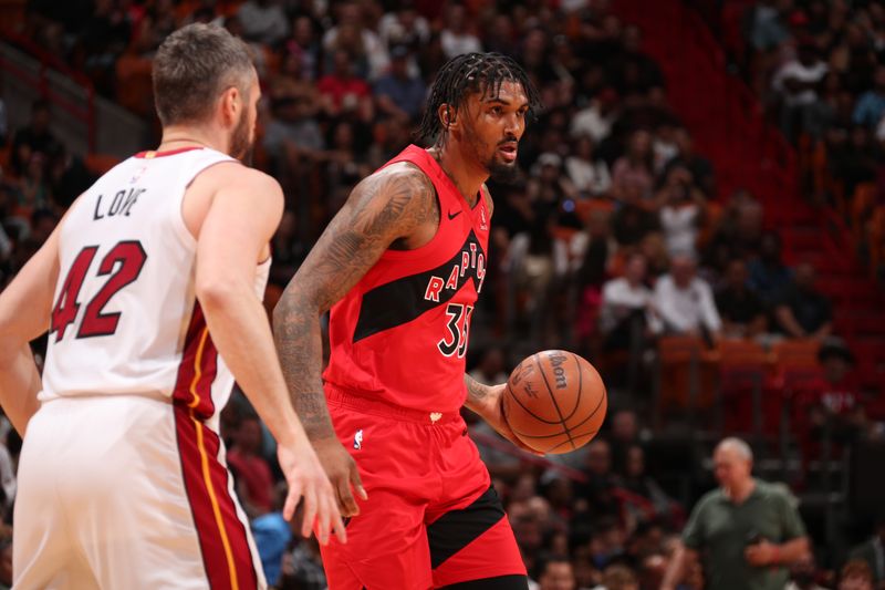 MIAMI, FL - APRIL 12:  Malik Williams #35 of the Toronto Raptor dribbles the ball during the game against the Miami Heat on April 12, 2024 at Kaseya Center in Miami, Florida. NOTE TO USER: User expressly acknowledges and agrees that, by downloading and or using this Photograph, user is consenting to the terms and conditions of the Getty Images License Agreement. Mandatory Copyright Notice: Copyright 2024 NBAE (Photo by Issac Baldizon/NBAE via Getty Images)