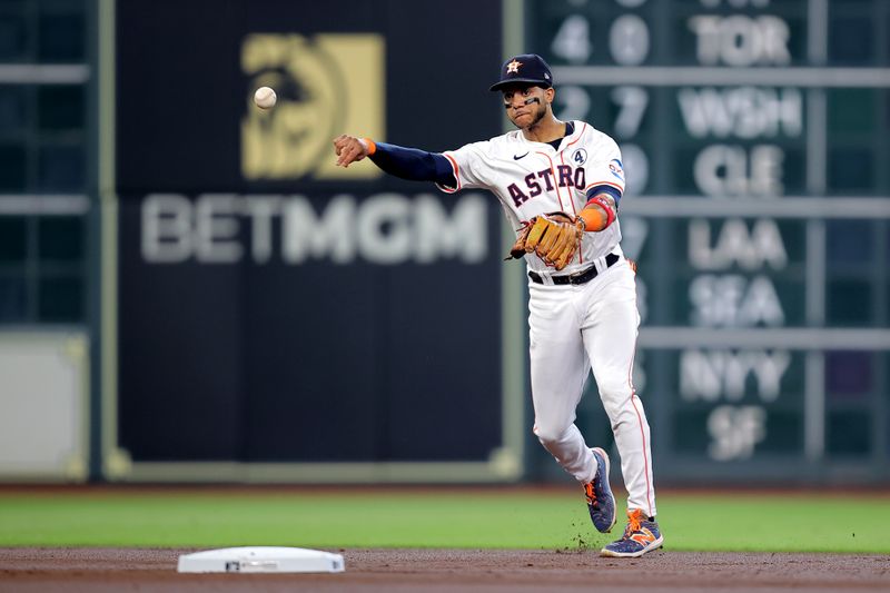 Jun 2, 2024; Houston, Texas, USA; Houston Astros shortstop Jeremy Pena (3) throws a fielded ball to first base for an out against the Minnesota Twins during the first inning at Minute Maid Park. Mandatory Credit: Erik Williams-USA TODAY Sports