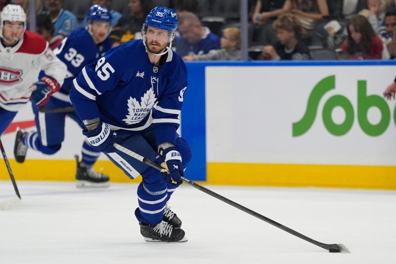 Sep 27, 2025; Toronto, Ontario, CAN; Toronto Maple Leafs defenseman Oliver Ekman-Larsson (95) carries the puck against the Montreal Canadiens during the second period at Scotiabank Arena. Mandatory Credit: John E. Sokolowski-Imagn Images