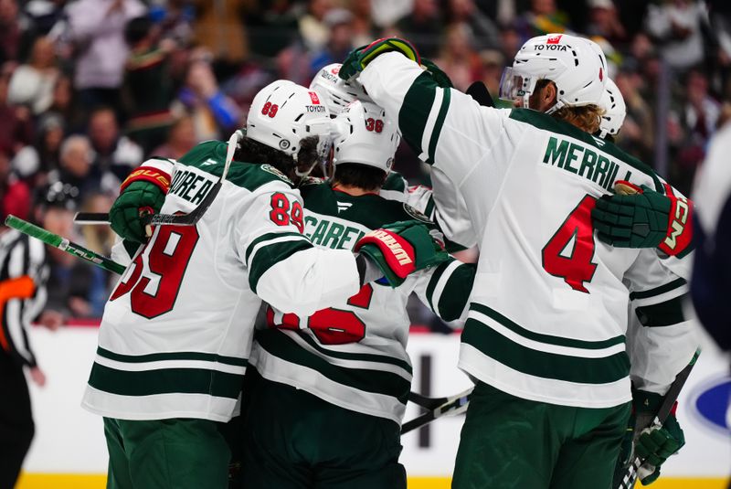 Feb 28, 2025; Denver, Colorado, USA; Minnesota Wild right wing Mats Zuccarello (36) (center) celebrates his goal with center Frederick Gaudreau (89) and defenseman Jon Merrill (4) in the first period against the Colorado Avalanche at Ball Arena. Mandatory Credit: Ron Chenoy-Imagn Images