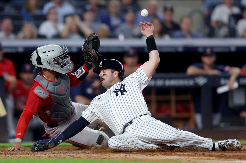 Jun 6, 2025; Bronx, New York, USA; New York Yankees catcher Austin Wells (28) scores against Boston Red Sox catcher Carlos Narvaez (75) on a double by Yankees right fielder Aaron Judge (99) during the fifth inning at Yankee Stadium. Mandatory Credit: Brad Penner-Imagn Images