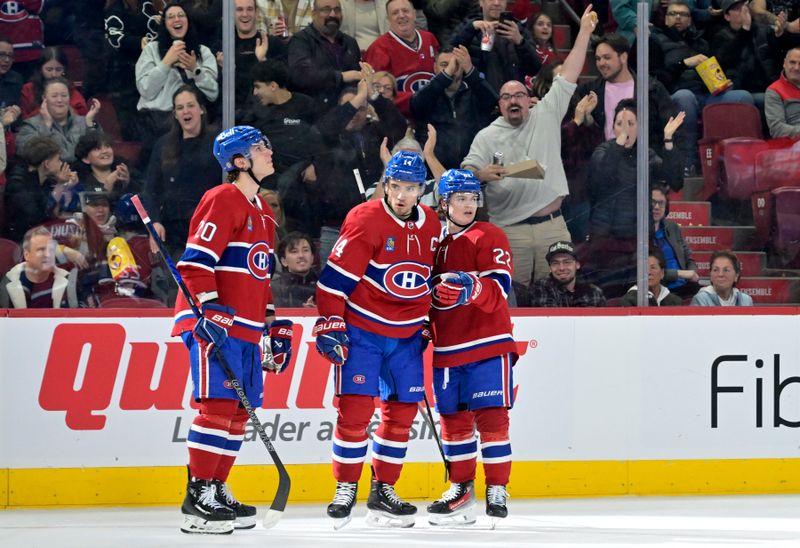 Apr 2, 2024; Montreal, Quebec, CAN; Montreal Canadiens forward Nick Suzuki (14) celebrates with teammates forward Juraj Slafkovsky (20) and forward Cole Caufield (22) after scoring a goal against the Florida Panthers during the second period at the Bell Centre. Mandatory Credit: Eric Bolte-USA TODAY Sports