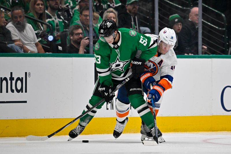 Oct 12, 2024; Dallas, Texas, USA; Dallas Stars center Wyatt Johnston (53) and New York Islanders center Bo Horvat (14) battle for control of the puck during the third period at the American Airlines Center. Mandatory Credit: Jerome Miron-Imagn Images