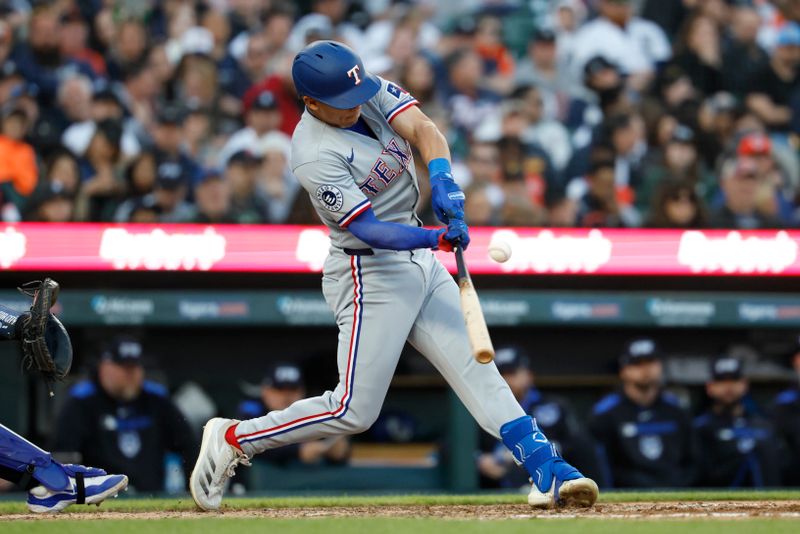 May 9, 2025; Detroit, Michigan, USA;  Texas Rangers shortstop Sam Haggerty hits an RBI single in the sixth inning against the Detroit Tigers at Comerica Park. Mandatory Credit: Rick Osentoski-Imagn Images