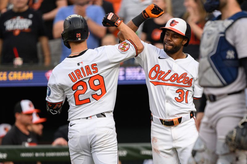 Apr 30, 2025; Baltimore, Maryland, USA; Baltimore Orioles third baseman Ramon Urias (29) celebrates with outfielder Cedric Mullins (31) after hitting a home run during the second inning against the New York Yankees at Oriole Park at Camden Yards. Mandatory Credit: Reggie Hildred-Imagn Images
