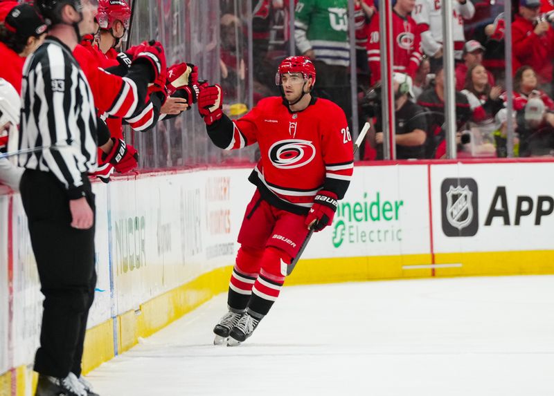 Nov 29, 2024; Raleigh, North Carolina, USA;  Carolina Hurricanes defenseman Sean Walker (26) celebrates his goal against the Florida Panthers during the second period at Lenovo Center. Mandatory Credit: James Guillory-Imagn Images