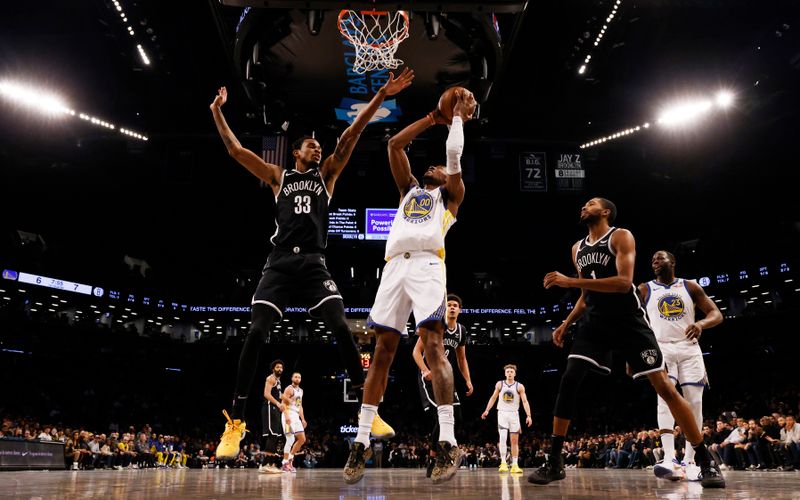 NEW YORK, NEW YORK - FEBRUARY 05:  Jonathan Kuminga #00 of the Golden State Warriors shoots against Nic Claxton #33 of the Brooklyn Nets during their game at Barclays Center on February 05, 2024 in New York City.   User expressly acknowledges and agrees that, by downloading and or using this photograph, User is consenting to the terms and conditions of the Getty Images License Agreement.  (Photo by Al Bello/Getty Images)