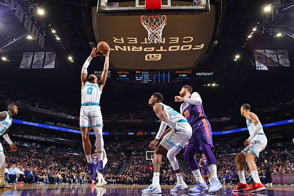 PHOENIX, AZ - DECEMBER 29: Miles Bridges #0 of the Charlotte Hornets rebounds the ball during the game against the Phoenix Suns on December 29 2023 at Footprint Center in Phoenix, Arizona. NOTE TO USER: User expressly acknowledges and agrees that, by downloading and or using this photograph, user is consenting to the terms and conditions of the Getty Images License Agreement. Mandatory Copyright Notice: Copyright 2023 NBAE (Photo by Barry Gossage/NBAE via Getty Images)