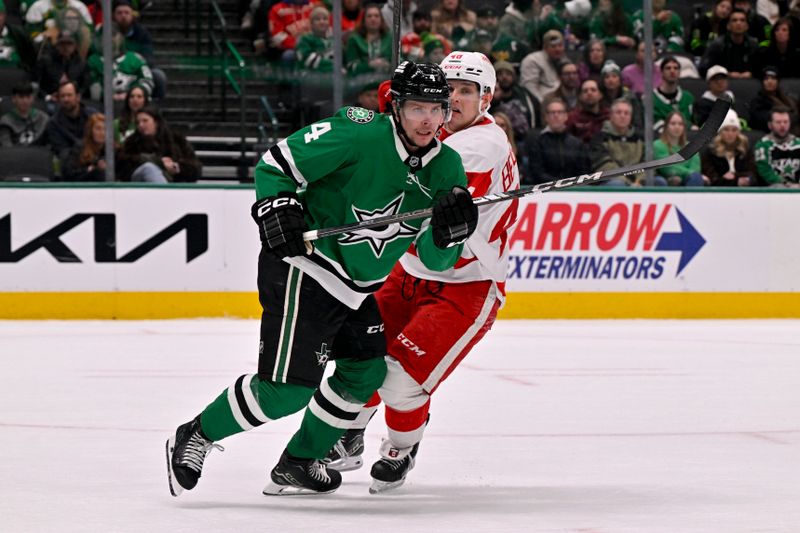 Jan 19, 2025; Dallas, Texas, USA; Dallas Stars defenseman Miro Heiskanen (4) and Detroit Red Wings right wing Jonatan Berggren (48) chase the puck during the third period at the American Airlines Center. Mandatory Credit: Jerome Miron-Imagn Images