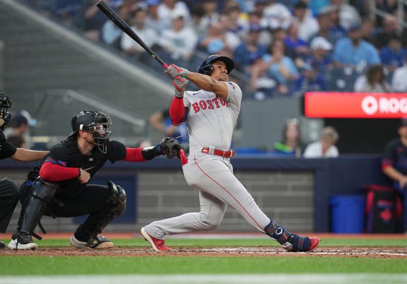 Jun 19, 2024; Toronto, Ontario, CAN; Boston Red Sox second base Enmanuel Valdez (47) hits a home run against the Toronto Blue Jays during fourth inning at Rogers Centre. Mandatory Credit: Nick Turchiaro-USA TODAY Sports