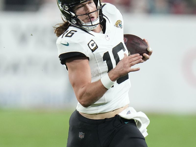 Jacksonville Jaguars quarterback Trevor Lawrence (16) runs against the Tampa Bay Buccaneers during the second half of an NFL football game Sunday, Dec. 24, 2023, in Tampa, Fla. (AP Photo/Chris O'Meara)