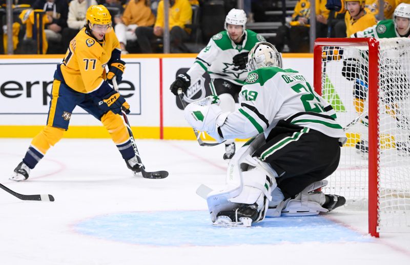 Oct 10, 2024; Nashville, Tennessee, USA;  Dallas Stars goaltender Jake Oettinger (29) blocks the shot of Nashville Predators right wing Luke Evangelista (77) during the first period at Bridgestone Arena. Mandatory Credit: Steve Roberts-Imagn Images