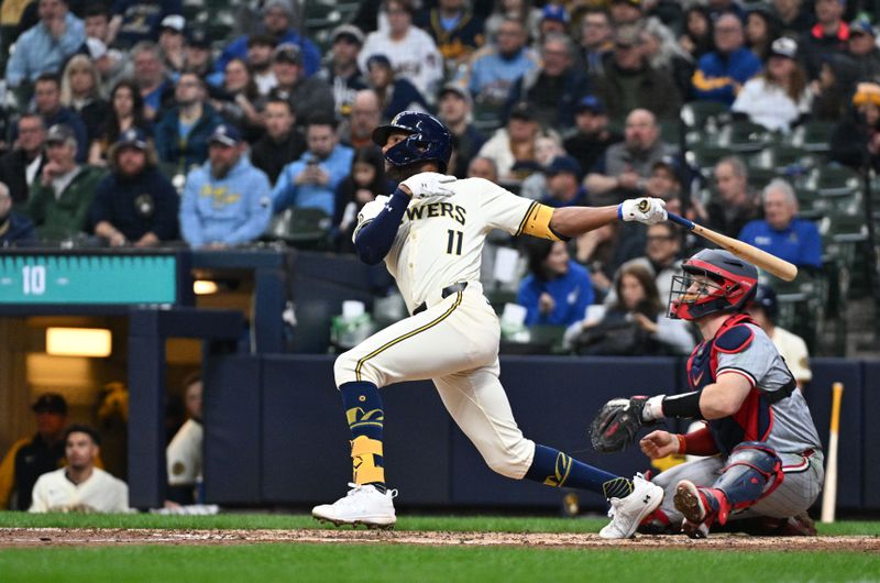 Apr 3, 2024; Milwaukee, Wisconsin, USA; Milwaukee Brewers right fielder Jackson Chourio (11) hits his first Major League home run against the Minnesota Twins in the fifth inning at American Family Field. Mandatory Credit: Michael McLoone-USA TODAY Sports