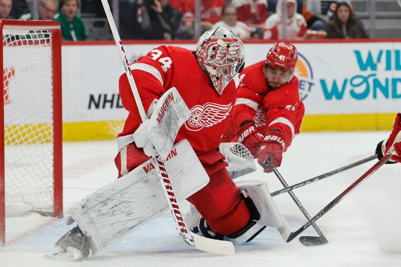 Jan 25, 2024; Detroit, Michigan, USA;  Detroit Red Wings goaltender Alex Lyon (34) makes a save in the first period against the Philadelphia Flyers at Little Caesars Arena. Mandatory Credit: Rick Osentoski-USA TODAY Sports