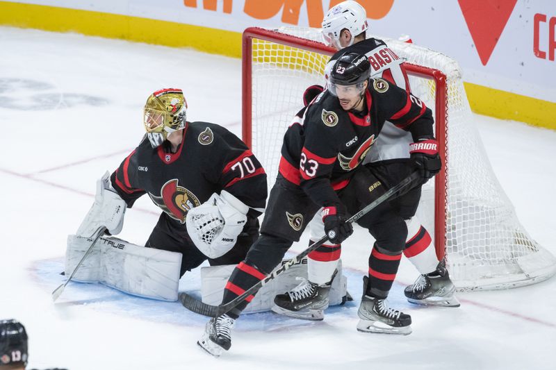 Dec 29, 2023; Ottawa, Ontario, CAN; Ottawa Senators defenseman Travis Hamonic (23) defends against New Jersey Devils right wing Nathan Bastian (14) in the third period at the Canadian Tire Centre. Mandatory Credit: Marc DesRosiers-USA TODAY Sports