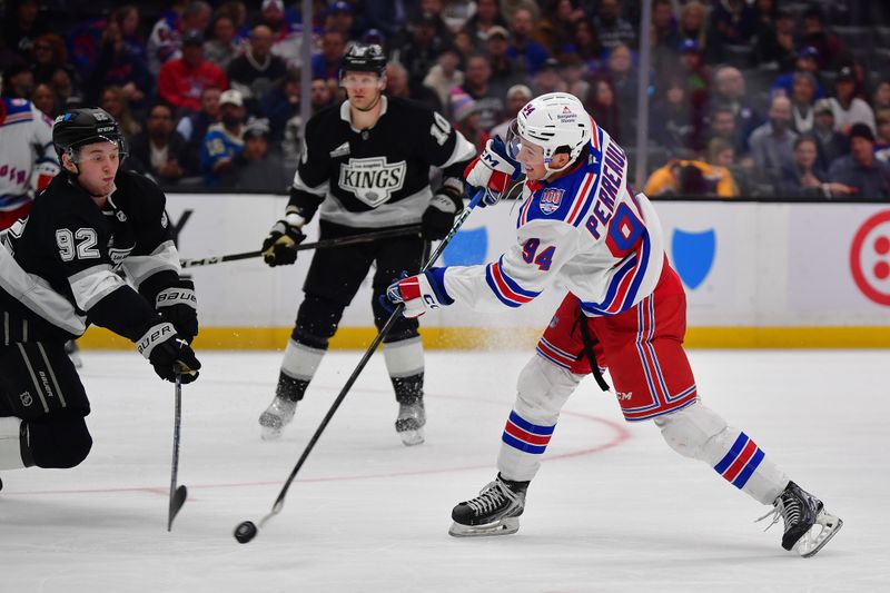 Jan 20, 2026; Los Angeles, California, USA; New York Rangers right wing Gabe Perreault (94) shoots against Los Angeles Kings defenseman Brandt Clarke (92) during the third period at Crypto.com Arena. Mandatory Credit: Gary A. Vasquez-Imagn Images