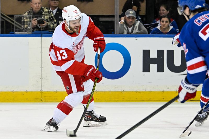 Oct 14, 2024; New York, New York, USA;  Detroit Red Wings right wing Alex DeBrincat (93) attempts a shot against the New York Rangers during the second period at Madison Square Garden. Mandatory Credit: Dennis Schneidler-Imagn Images