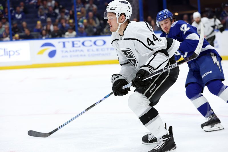 Jan 9, 2024; Tampa, Florida, USA; Los Angeles Kings defenseman Mikey Anderson (44) skates as Tampa Bay Lightning center Alex Barre-Boulet (12) defends during the third period at Amalie Arena. Mandatory Credit: Kim Klement Neitzel-USA TODAY Sports