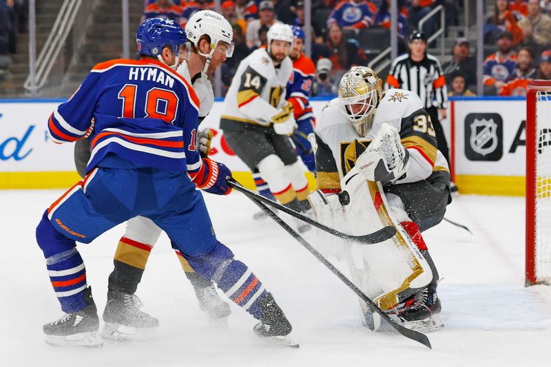 Apr 10, 2024; Edmonton, Alberta, CAN; Vegas Golden Knights goaltender Adin Hill (33) makes a save on a deflection. By Edmonton Oilers forward Zach Hyman (18) during the first period at Rogers Place. Mandatory Credit: Perry Nelson-USA TODAY Sports