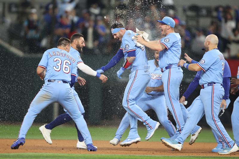 Apr 6, 2025; Arlington, Texas, USA; Texas Rangers catcher Jonah Heim (28) and his teammates celebrate after he singled in the winning run in the bottom of the ninth inning against the Tampa Bay Rays at Globe Life Field. Mandatory Credit: Tim Heitman-Imagn Images