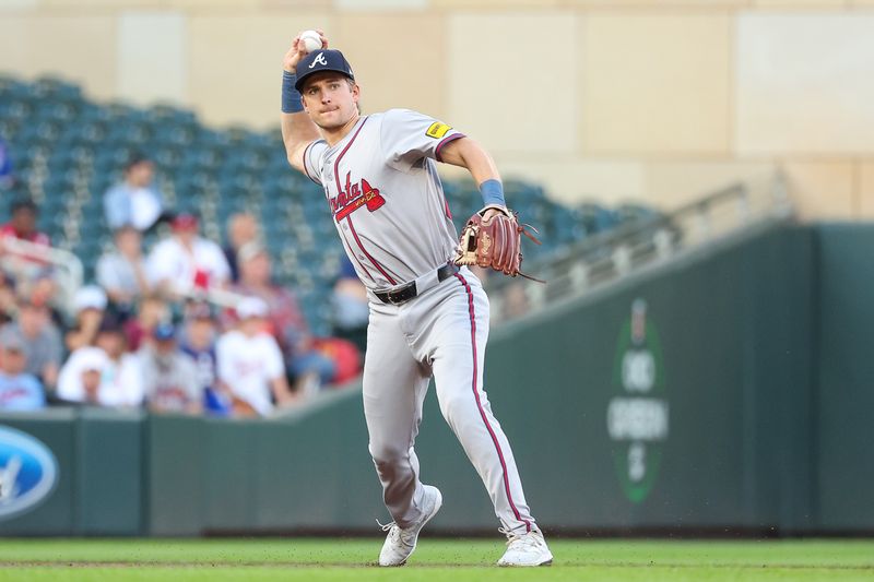 Aug 28, 2024; Minneapolis, Minnesota, USA; Atlanta Braves third baseman Luke Williams (65) throws the ball to first base to get out Minnesota Twins first baseman Carlos Santana (30) during the second inning at Target Field. Mandatory Credit: Matt Krohn-USA TODAY Sports