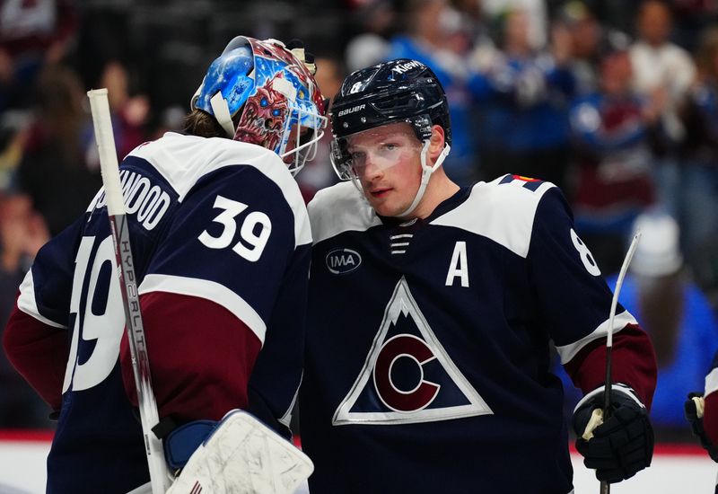 Feb 28, 2025; Denver, Colorado, USA; Colorado Avalanche goaltender Mackenzie Blackwood (39) and defenseman Cale Makar (8) celebrate defeating the Minnesota Wild in the third period at Ball Arena. Mandatory Credit: Ron Chenoy-Imagn Images