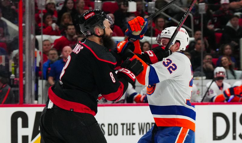 Apr 22, 2024; Raleigh, North Carolina, USA; Carolina Hurricanes defenseman Brent Burns (8) checks New York Islanders center Kyle MacLean (32) during the second period in game two of the first round of the 2024 Stanley Cup Playoffs at PNC Arena. Mandatory Credit: James Guillory-USA TODAY Sports