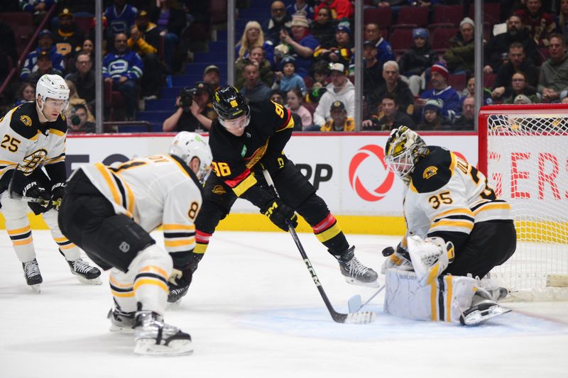 Feb 25, 2023; Vancouver, British Columbia, CAN; Boston Bruins goaltender Linus Ullmark (35) blocks a shot on net by Vancouver Canucks forward Andrei Kuzmenko (96) during the first period at Rogers Arena. Mandatory Credit: Anne-Marie Sorvin-USA TODAY Sports