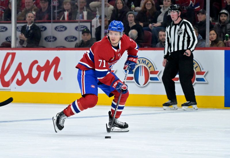 Oct 26, 2024; Montreal, Quebec, CAN; Montreal Canadiens forward Jake Evans (71) plays the puck against the St.Louis Blues during the third period at the Bell Centre. Mandatory Credit: Eric Bolte-Imagn Images