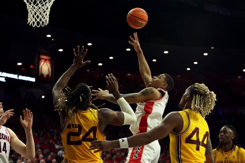 Feb 17, 2024; Tucson, Arizona, USA; Arizona Wildcats forward Keshad Johnson (16) shoots a basket against Arizona State Sun Devils forward Bryant Selebangue (24) during the second half at McKale Center. Mandatory Credit: Zachary BonDurant-USA TODAY Sports