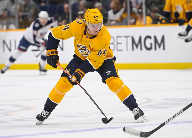 Jan 17, 2023; Nashville, Tennessee, USA;  Nashville Predators center Mikael Granlund (64) skates against the Columbus Blue Jackets during the first period at Bridgestone Arena. Mandatory Credit: Steve Roberts-USA TODAY Sports