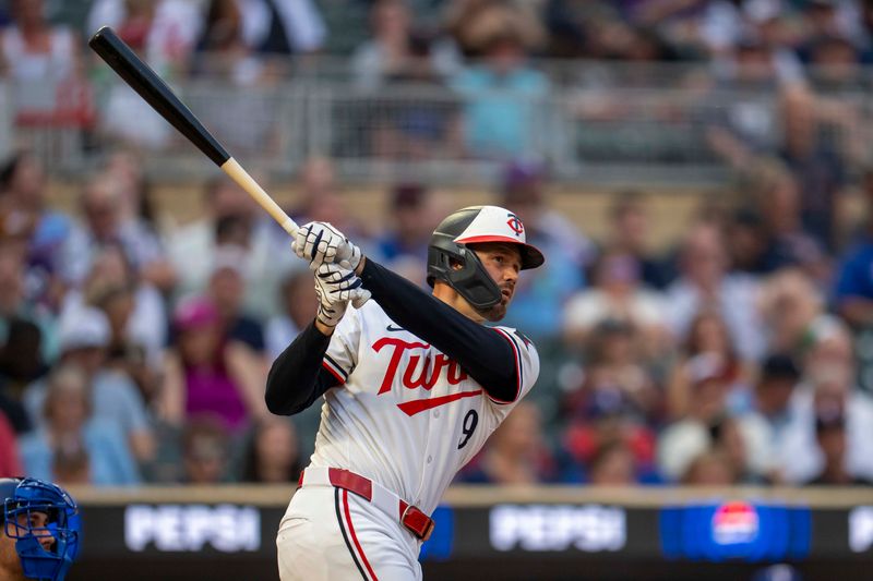 Jun 10, 2025; Minneapolis, Minnesota, USA; Minnesota Twins designated hitter Trevor Larnach (9) hits a double against the Texas Rangers in the fifth inning at Target Field. Mandatory Credit: Jesse Johnson-Imagn Images