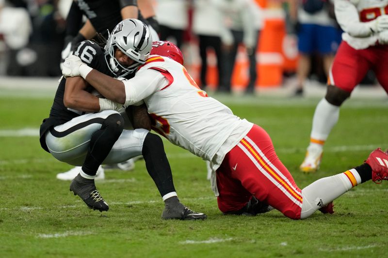 Las Vegas Raiders wide receiver Jakobi Meyers (16) is stopped for no gain by Kansas City Chiefs defensive tackle Chris Jones during the first half of an NFL football game Sunday, Oct. 27, 2024, in Las Vegas. (AP Photo/John Locher)