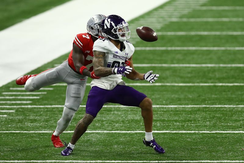 Dec 19, 2020; Indianapolis, Indiana, USA; Ohio State Buckeyes cornerback Sevyn Banks (7) breaks up a pass interned for Northwestern Wildcats wide receiver Ramaud Chiaokhiao-Bowman (81) during the second half at Lucas Oil Stadium. Mandatory Credit: Aaron Doster-USA TODAY Sports